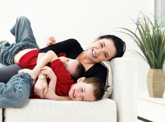 A mother playing with two children