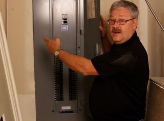 A Cadet staff member installing a baseboard heater