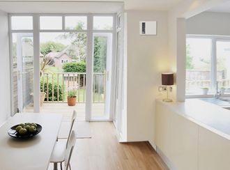 An indoor dining area with an Apex72 heater built into a wall