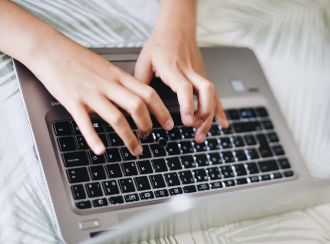 A person typing on a laptop