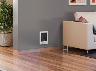 An indoor living space with a Com-Pak Series heater built into the wall