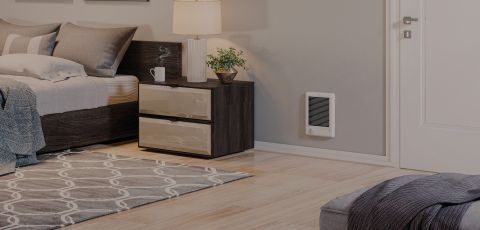 A bedroom with a Com-Pak Series heater built into the wall