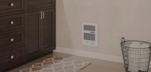 A bedroom with a Com-Pak Series heater built into the wall