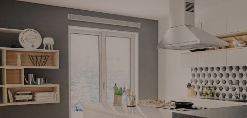 A living space with a Cadet Cove heater mounted onto the wall above a door
