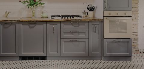 A kitchen with a Cadet heater built into the plinth under the cupboards