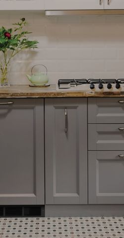 A kitchen with a Cadet heater built into the plinth under the cupboards