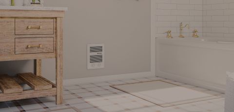 A bathroom with a Cadet heater built into the wall
