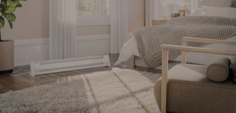 A bedroom with a Cadet portable heater plugged into the wall