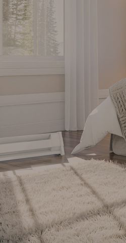 A bedroom with a Cadet portable heater plugged into the wall