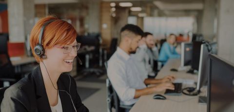 A support agent smiling while on a call