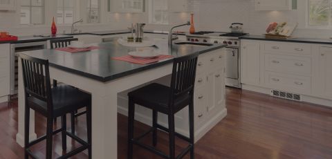 A kitchen with a Cadet heater built into the plinth under the cupboards