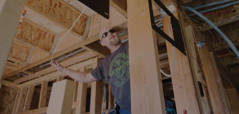 A man installing a wall heater