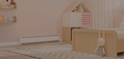 A child's bedroom with a Cadet Baseboard heater mounted to the wall 