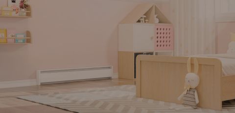 A child's bedroom with a Cadet Baseboard heater mounted to the wall