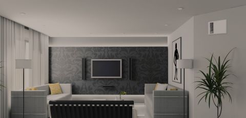 An indoor living space with a TV mounted on the wall and an Apex72 heater built into another wall