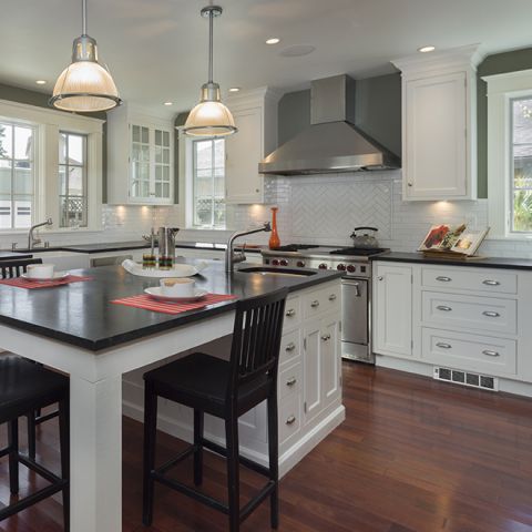 A kitchen with a perfectoe wall heater in the kick space below the bench